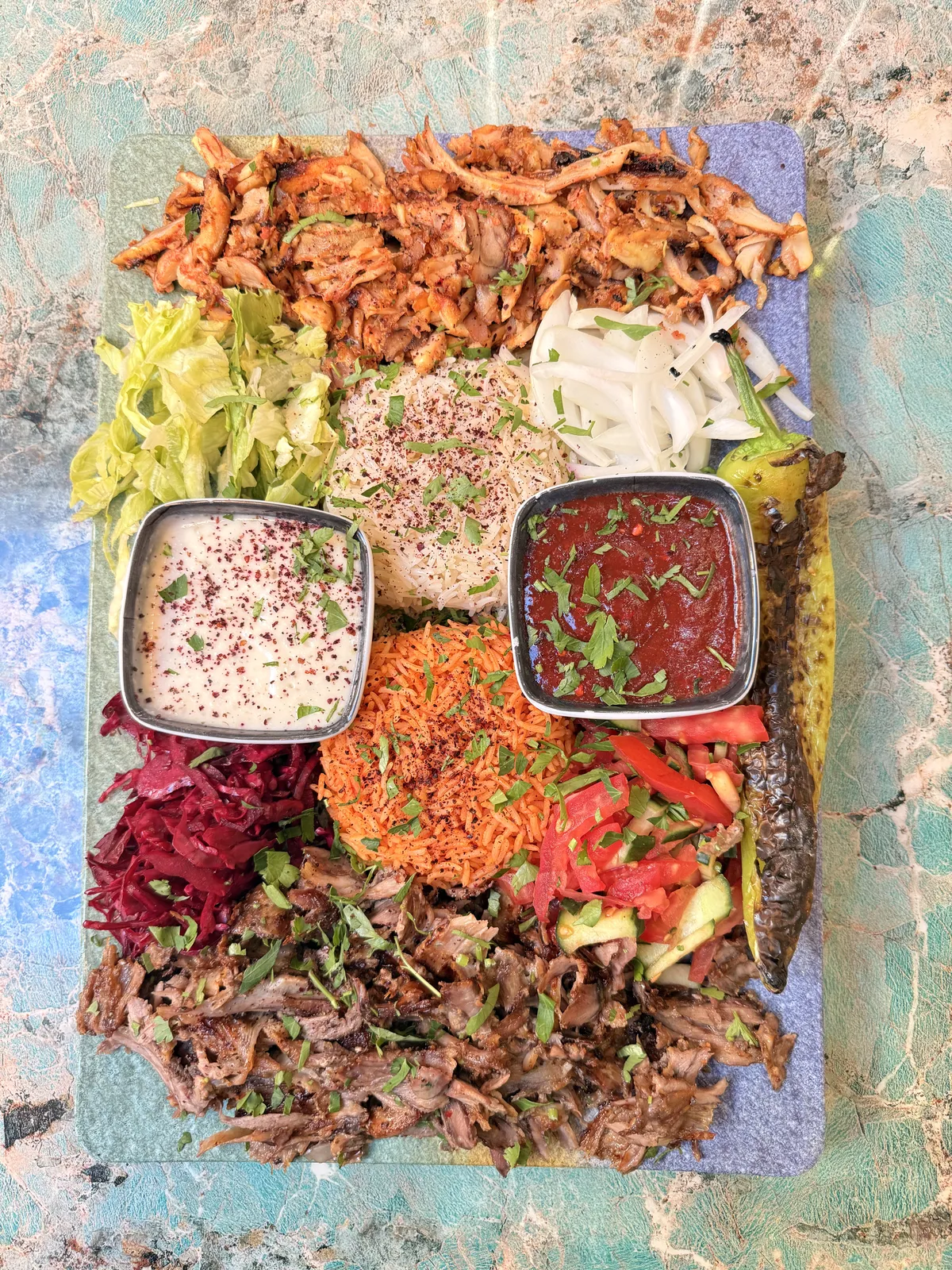 Mixed shawarma platter with rice, salad and sauces