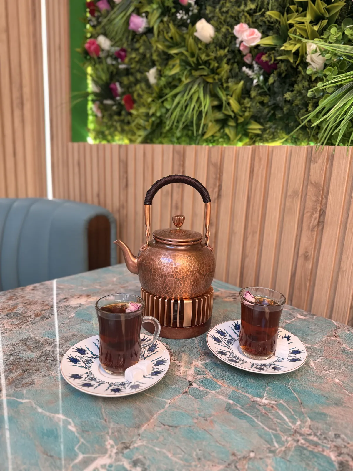 Copper teapot with two glasses of tea served on the table